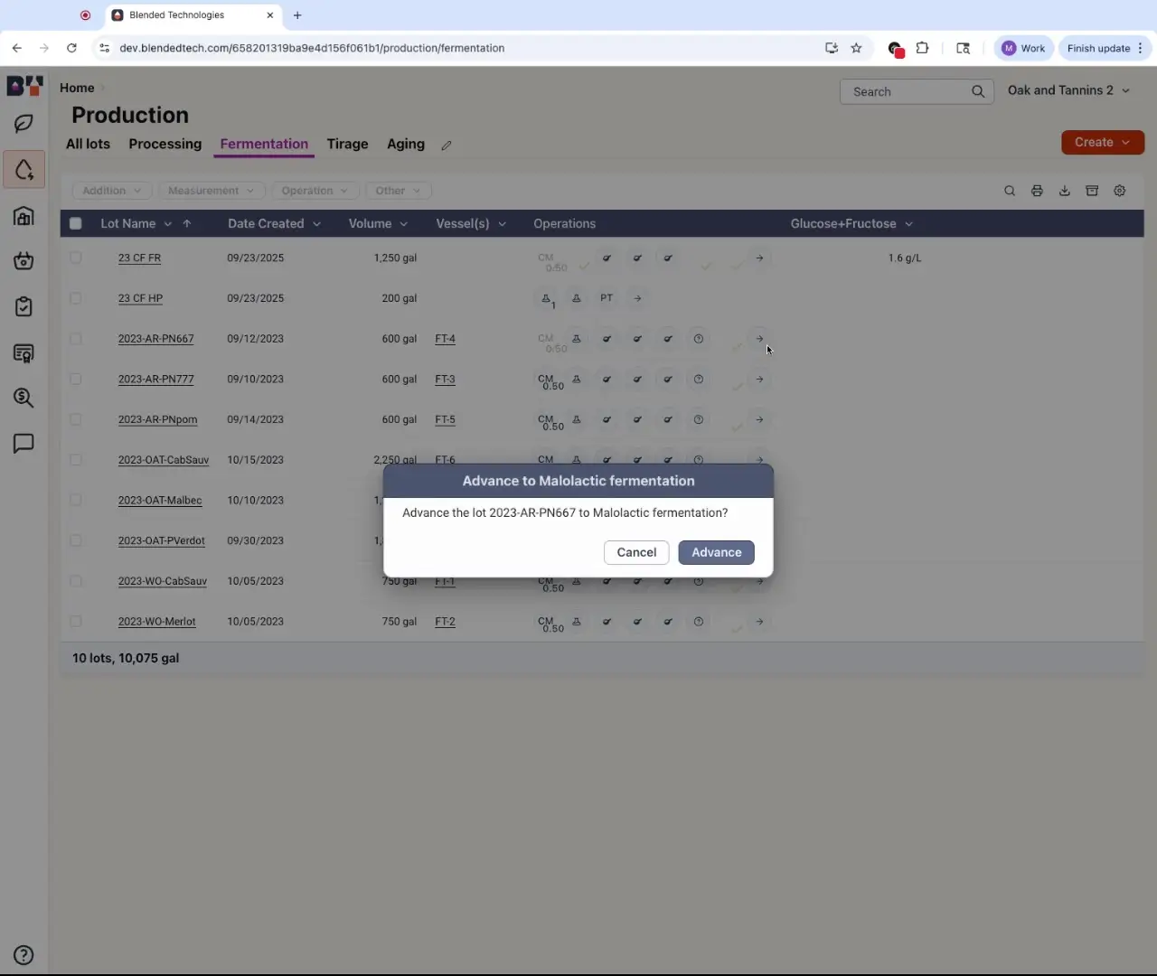 The user is viewing the fermentation section of the production dashboard. A modal is open, prompting the user to advance the lot 2023-AR-PN667 to malolactic fermentation.